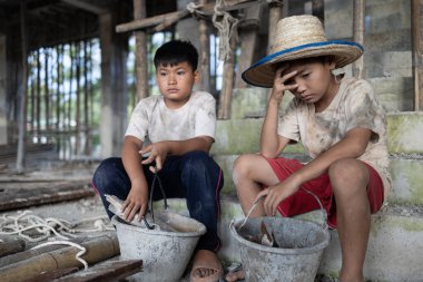 Children working at construction site. Concept against child labor and human trafficking for world day against child labor concept.