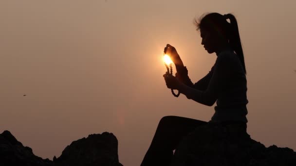 年轻的人的手的剪影祈祷对上帝在日出时 基督徒宗教概念背景 — 图库视频影像