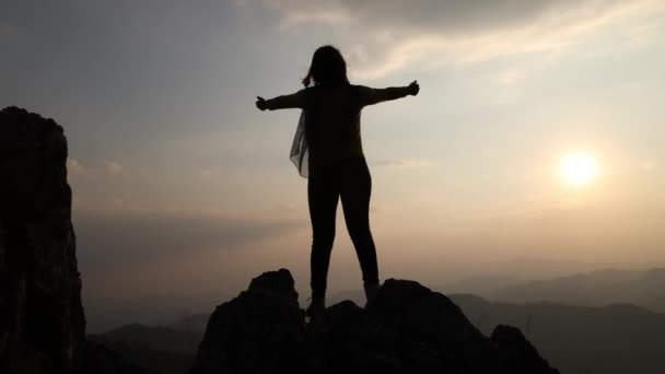 Silhouette Woman Sitting Rock Her Hands Clasped Together Slowly Opening — Stock Video