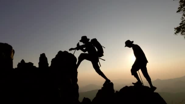 꼭대기에 일몰에 꼭대기에 하이킹 사람들의 실루엣 산에서 성공을 리더십 팀워크 — 비디오