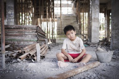 Poor children are forced to work in construction. Child labor in building commercial building structures. World Labor Day concept.
