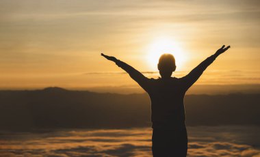 Silhouette of woman  praying over beautiful sunrise background, beautiful landscape, pay homage, spirituality and religion,man praying to god. Christianity concept.