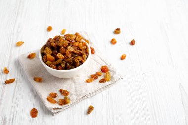 White Bowl 'da organik kuru üzümler, yan görüş. Boşluğu kopyala.