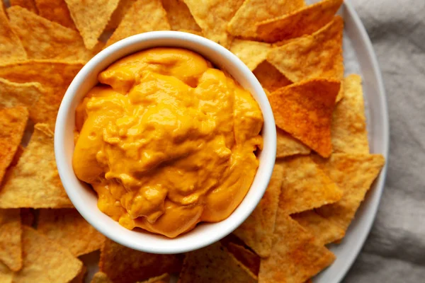 Cheese dip with tortilla chips, top view. Flat lay, overhead, from above. Close-up.