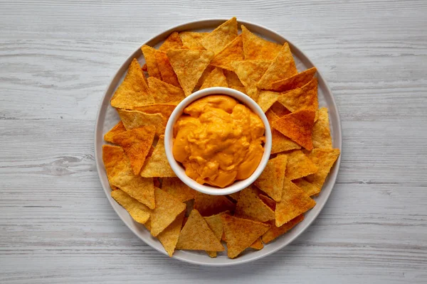 Cheese dip with tortilla chips, top view. Flat lay, overhead, from above.