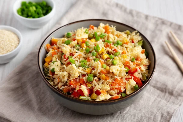 stock image Homemade Cauliflower Fried Rice with Chives and Sesame Seeds in a Bowl, low angle view.