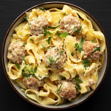 Ev yapımı İsveç Köfteli Köfteli Makarna. Siyah arka planda, üst tarafta. Dümdüz, tepeden, yukarıdan. Yakın plan..