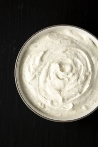 Homemade Ranch Dressing in a Bowl on a black background, top view. Flat lay, overhead, from above.