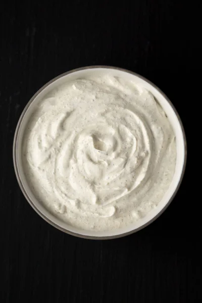 Homemade Ranch Dressing in a Bowl on a black background, top view. Flat lay, overhead, from above.
