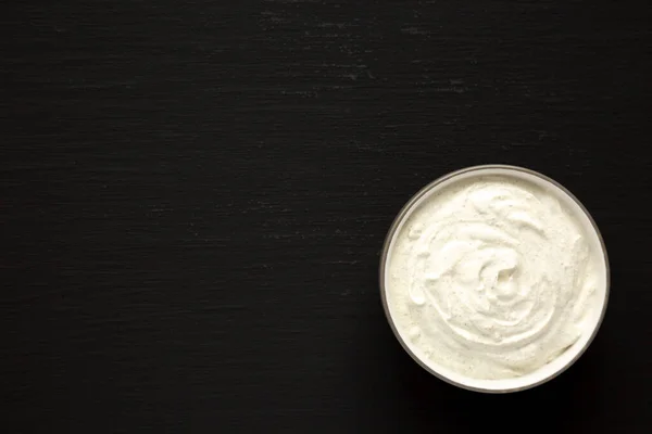 Homemade Ranch Dressing in a Bowl on a black background, top view. Flat lay, overhead, from above. Copy space.