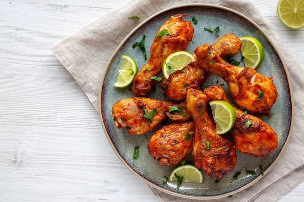 stock image Homemade Grilled Jerk Chicken with Lime on a Plate, top view. Flat lay, overhead, from above. Copy space.