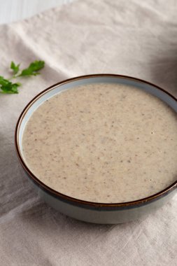 Homemade Cream of Mushroom Soup in a Bowl, side view. 