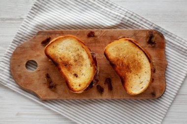 Homemade British Bacon Sandwich on a rustic wooden board, top view. Flat lay, overhead, from above.
