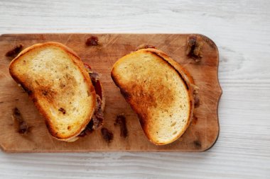 Homemade British Bacon Sandwich on a rustic wooden board, top view. Flat lay, overhead, from above.