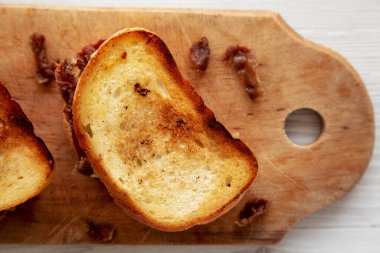 Homemade British Bacon Sandwich on a rustic wooden board, top view. Flat lay, overhead, from above. Close-up.
