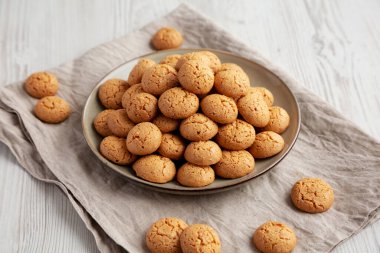Homemade Italian Amaretti Cookie Biscuits on a Plate, side view. 