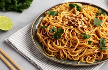 Homemade Asian Peanut Sauce Noodles on a Plate, low angle view.