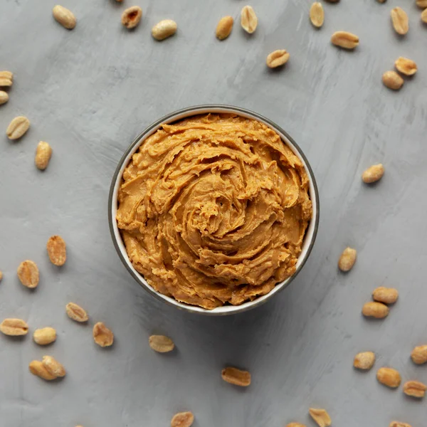 Yummy Organic Peanut Butter in a Bowl, top view. Flat lay, overhead, from above.