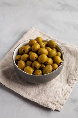 Marinated Green Pitted Olives in a Bowl, side view.