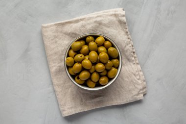 Marinated Green Pitted Olives in a Bowl, top view. Flat lay, overhead, from above.