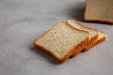 Sliced Whole Wheat White Bread on a gray background, side view. Copy space.