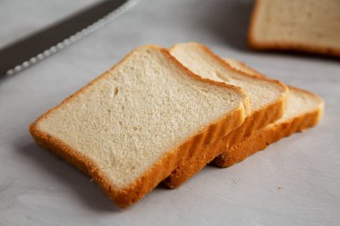 Sliced Whole Wheat White Bread on a gray background, side view. Close-up.