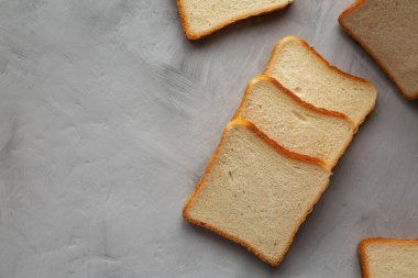 Sliced Whole Wheat White Bread on a gray background, top view. Flat lay, overhead, from above. Copy space.