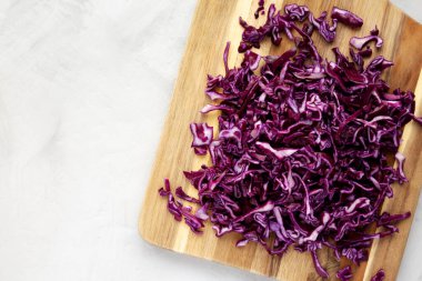 Shredded Purple Cabbage on a Board, top view. Flat lay, overhead, from above.