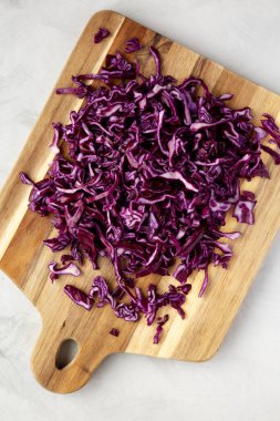 Shredded Purple Cabbage on a Board, top view. Flat lay, overhead, from above.