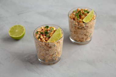 Homemade Mexican Corn Elote Esquites in Cups, side view.