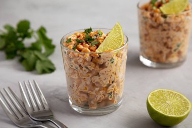 Homemade Mexican Corn Elote Esquites in Cups, side view. Close-up.