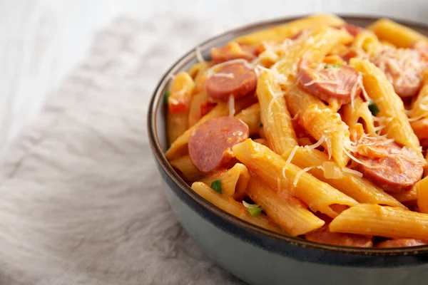 Homemade One-pot Hot Dog Pasta in a Bowl, side view. Space for text.