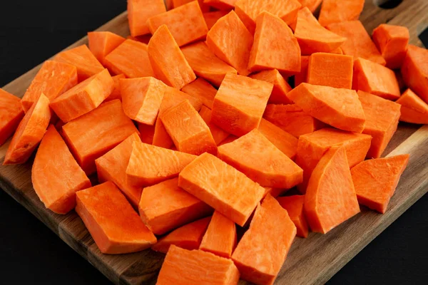 stock image Raw Chopped Sweet Potatoes on a Cutting Board, side view.