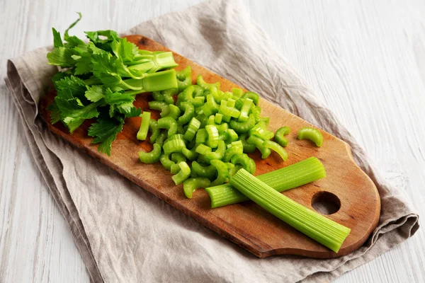 Stock image Raw Green Organic Celery on a rustic wooden board, low angle view. 