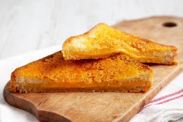 stock image Homemade Inside-Out Grilled Cheese Sandwich on a rustic wooden board, low angle view. Close-up.