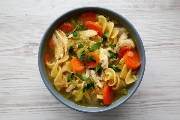 Stock image Homemade Chicken Noodle Soup in a Bowl, top view. Flat lay, overhead, from above.