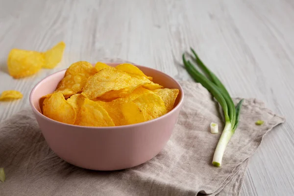 stock image Crunch Green Onion Potato Chips in a Pink Bowl, low angle view.