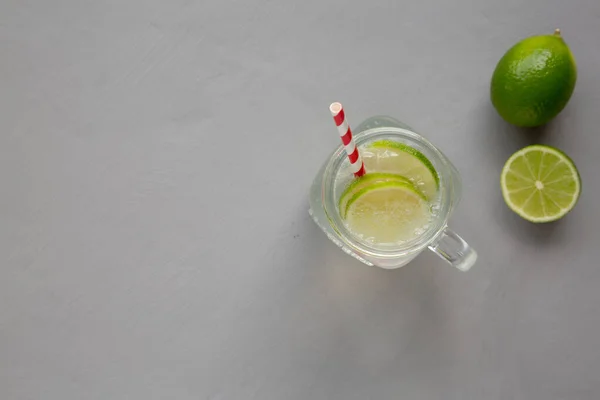 Cold Indian Nimbu Soda in a Glass Jar on a gray background, top view.