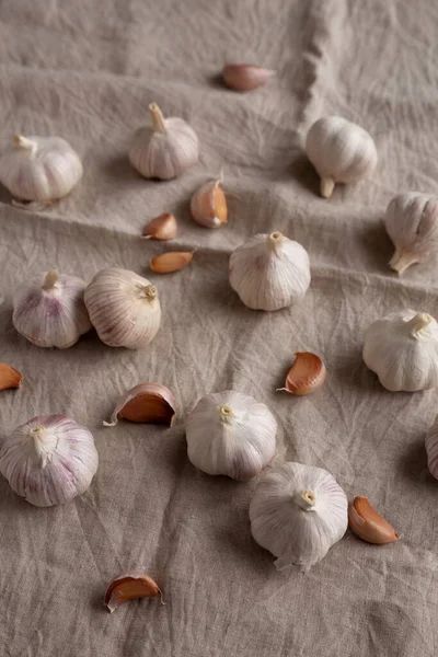 stock image Raw Organic White Garlic Bulbs on a cloth, side view. 