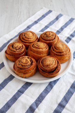 Beyaz ahşap arka planda ev yapımı tarçınlı çörek.. 