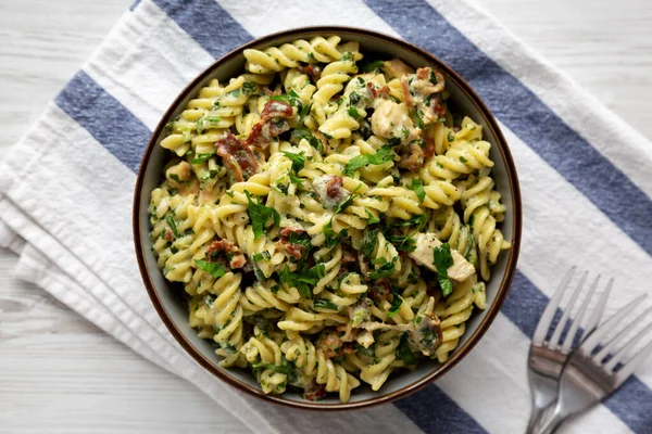 stock image Homemade Chicken Spinach Alfredo Rotini Pasta in a Bowl, top view. Flat lay, overhead, from above. 