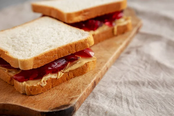 土制花生酱和果冻三明治放在乡村木木板上 侧视图 — 图库照片