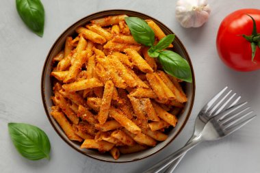 Peynirli ve fesleğenli ev yapımı domates pesto makarna. Dümdüz, tepeden, yukarıdan. Yakın plan..