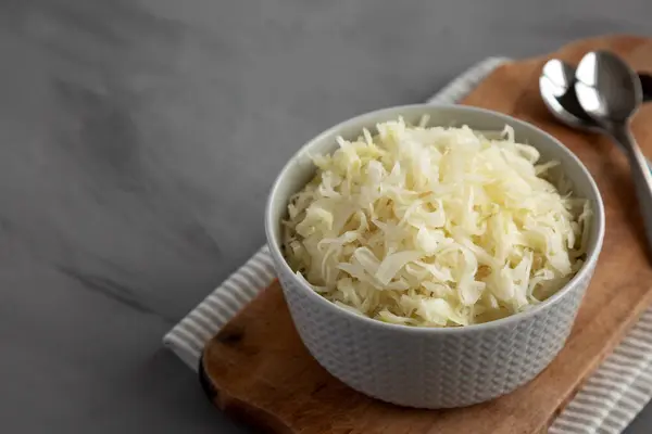 stock image Homemade German Sauerkraut in a Bowl on a gray background, side view. Copy space.