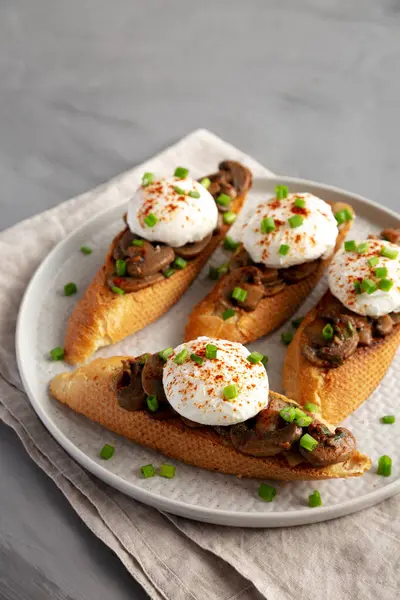 Homemade Creamy Mushroom Toasts on a Plate, side view. Space for text.