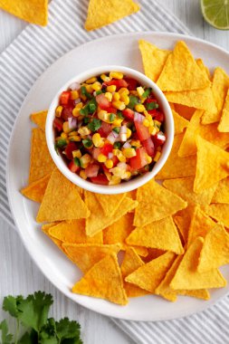 Ev yapımı Mısır Salsa 'sı ve bir tabak Tortilla Chips, en iyi manzara. Yukarıdan, dümdüz uzanmış.