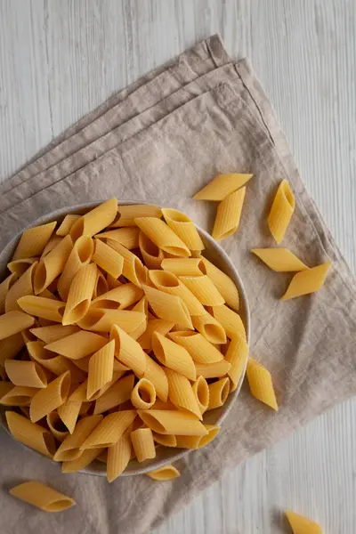 stock image Raw Organic Dry Pennoni Pasta in a Bowl, top view. Copy space.