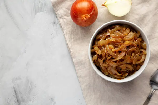 Stock image Organic Caramelized Onions in a Bowl, top view. Flat lay, overhead, from above. Copy space.