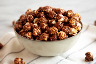 Homemade Chocolate Caramel Popcorn in a Bowl, side view. Close-up. clipart