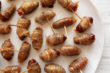 Ev yapımı pastırmalı pastırma. Tabağa yapıştırılmış tarihler, üst manzara. Yakın plan..